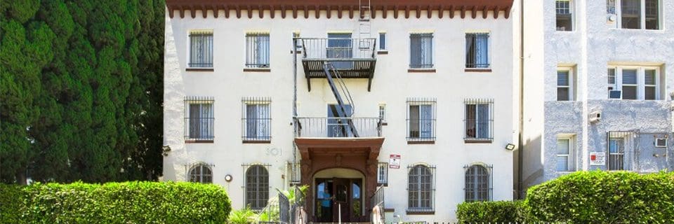 A building with fire escape stairs and balcony.